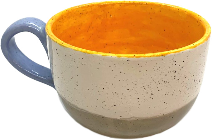 A ceramic cup with a speckled white exterior and orange interior, crafted by Brush & Co., featuring a smooth, wide handle in a light blue tone.
